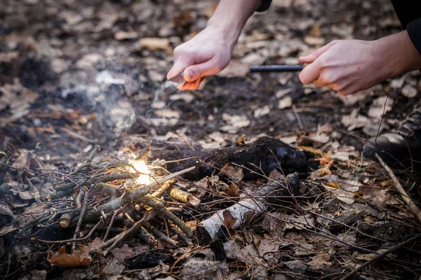 A man makes a fire with a flint