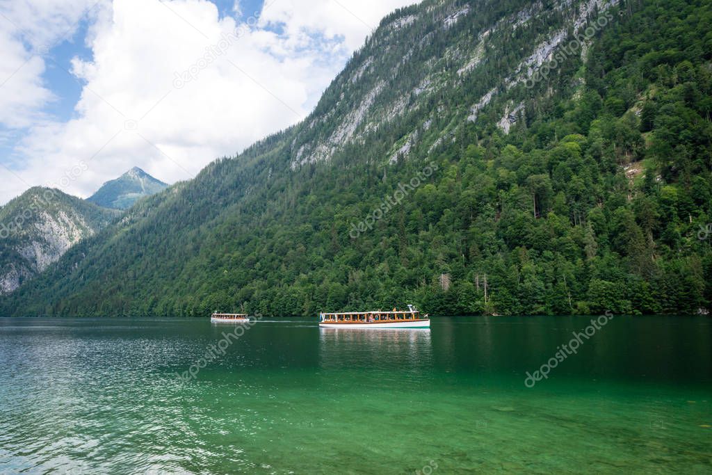 Tourist boats in Koningssee lake in german Alps. Landscape view.