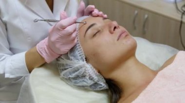 Yüzün derisini siyah noktalar ve sivilcelerden yapılmış kaşıkla temizleme işlemi..