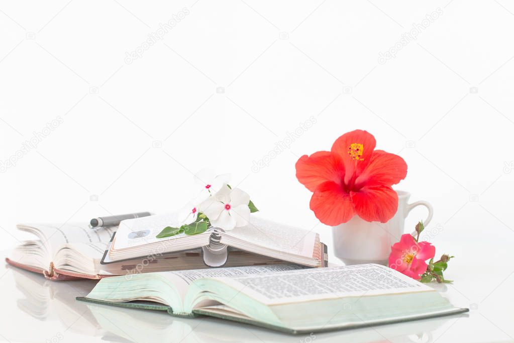 Open books with flowers and coffee in the morning.