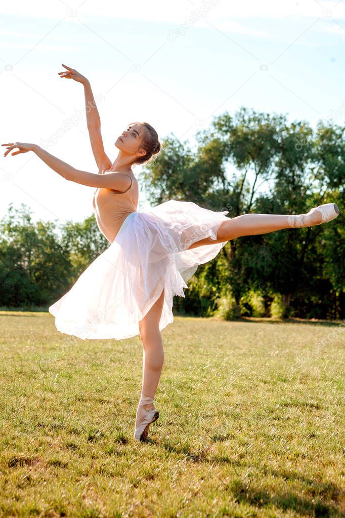 Sensual ballerina on nature in summer