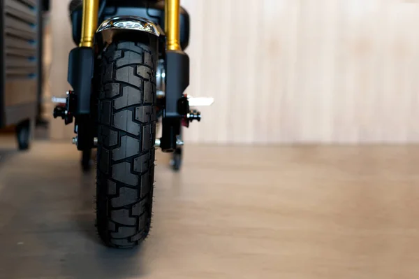 closeup tire of  sport motorcycle ( vintage bike ) with soft-focus and over light in the background. top view