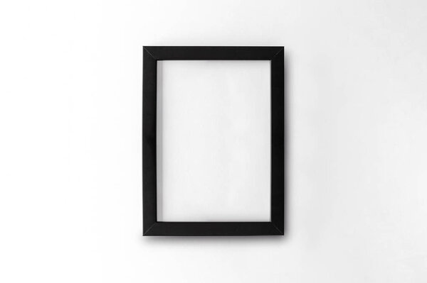 Blank black picture frame on white table background. top view