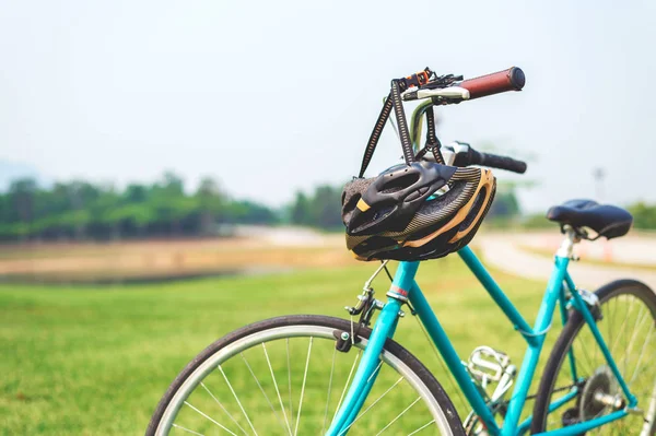 closeup helmet and bike with soft-focus and over light in the background