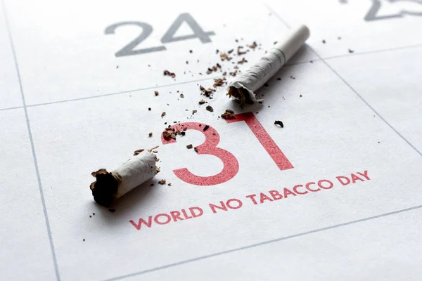 world no tobacco day concept. cigarettes on calendar with soft-focus and over light in the background