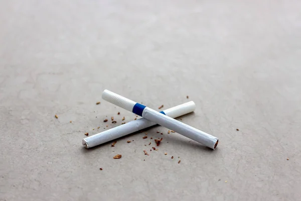 world no tobacco day concept. closeup cigarette on cement floor with soft-focus and over light in the background