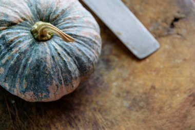 closeup pumpkin on chopping wood with soft-focus and over light in the background