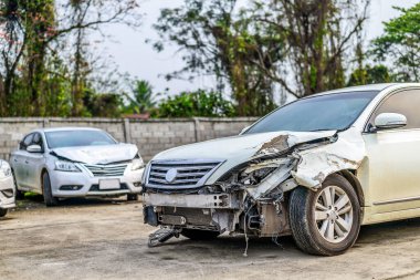 closeup car in front has been damaged by accident with soft-focus and over light in the background