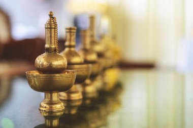 closeup buddhist water libation with soft-focus and over light in the background. Thai culture belief after death
