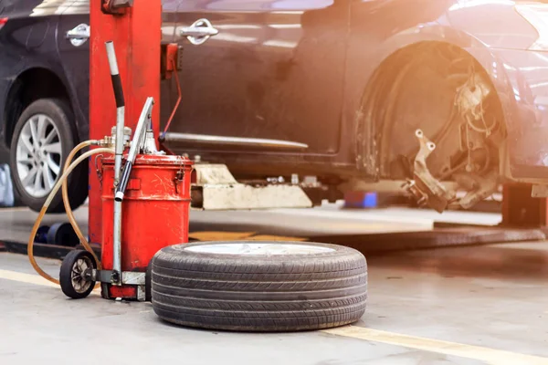 closeup tire and car parking repair garage with soft-focus in the background and over light