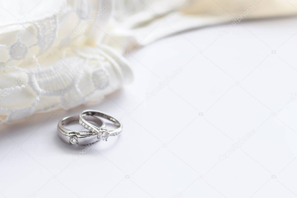 wedding ring on white table with soft-focus and over light in the background