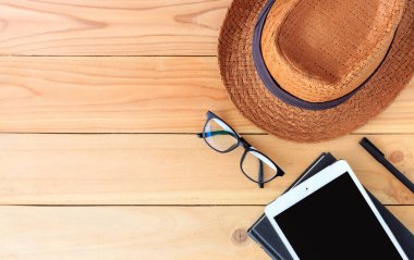 Plaj aksesuarları ve tablet bilgisayarı arka planda ışığın üzerinde.