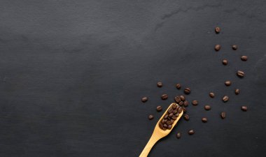 Siyah ahşap zemin üzerinde kahve çekirdeği. Üst Manzara. Metin için boşluk