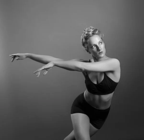 Ballerina dance in studio, black background