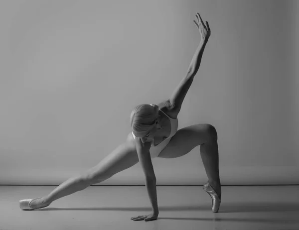 Ballerina dance on studio background, black and white