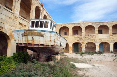 Quarantine and hospital building on Comino with abandoned boat, Malta clipart