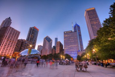Chicago, Illinois - July 15, 2017: Millennium Park, Chicago. Tourists visit Cloud Gate in Millennium Park in the late afternoon, also known as the Bean is one of the parks major attractions.  clipart