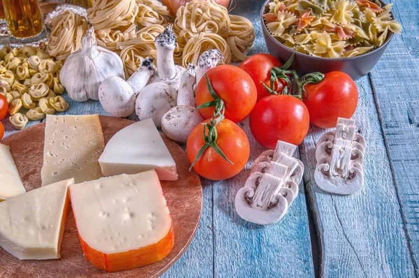 Raw Pasta with ingredients on wooden background. — Stock Photo, Image