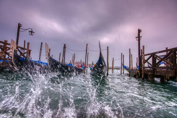 Gondolas parked at San Marco square with high tide. — Stock Photo, Image