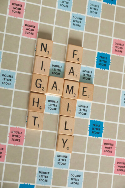 WOODBRIDGE, NEW JERSEY - October 9, 2018: A vintage Scrabble board game is shown with letter tiles spelling out Family Game Night.