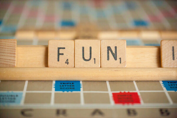 WOODBRIDGE, NEW JERSEY - October 9, 2018: A vintage Scrabble board game is shown with letter tiles spelling out fun.