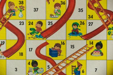 WOODBRIDGE, NEW JERSEY - October 9, 2018: A circa 1980s board game of Chutes and Ladders is shown. clipart