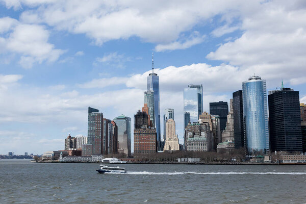 NEW YORK, NEW YORK - April 5, 2018: A view of the Lower Manhattan skyline from the Staten Island Ferry