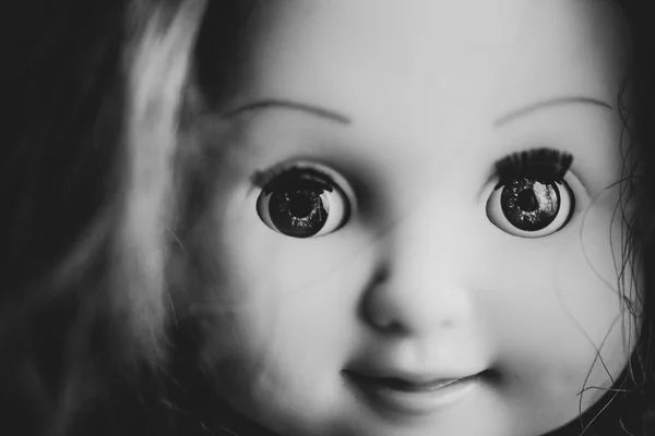 A closeup image of a creepy doll\'s face.