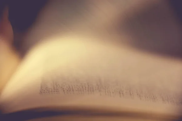 A unique view of book pages turning with a blur to show motion