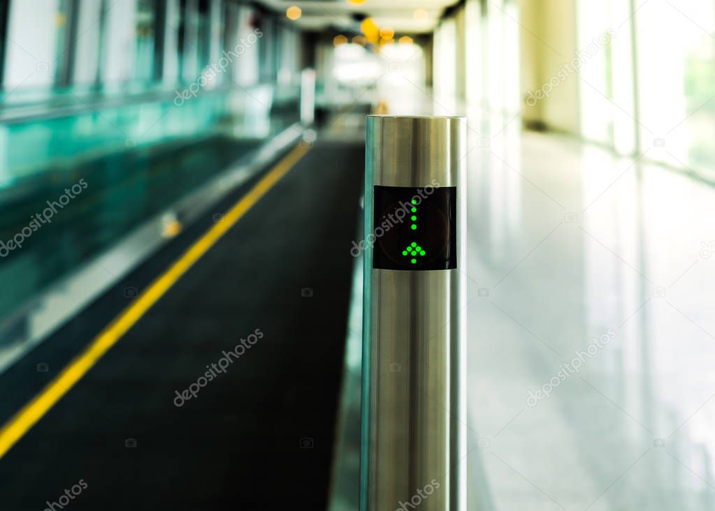 Post of a part of moving walkway shown signage lighting screen, journey and traveler concept, selective focus.