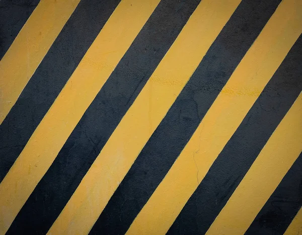 Striped black and yellow grunge background.