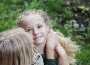 Annesi sarılma kız 7 yaşında mavi gözlü kameraya, seyir