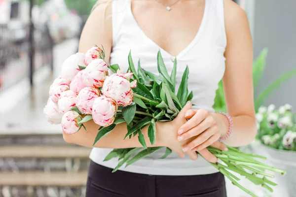 通りに白ピンクのシャクヤクの花束を持って若い女性 — ストック写真