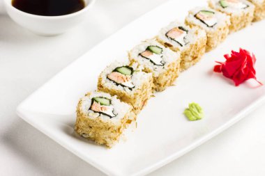 Japon Suşi rulo somon ve salatalık ile beyaz arka plan üzerinde avokado