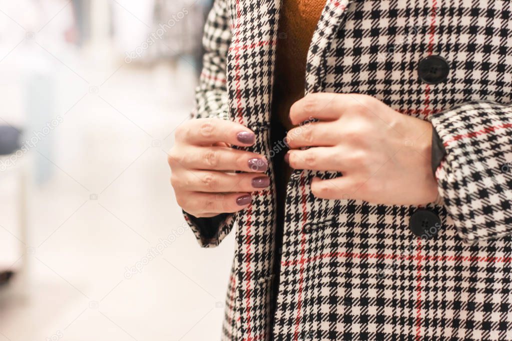 Woman trying on coat in cage in the store