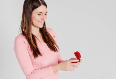Güzel esmer kız mutlu alınan yüzük teklif izole gri arka plan üzerine evlenmek