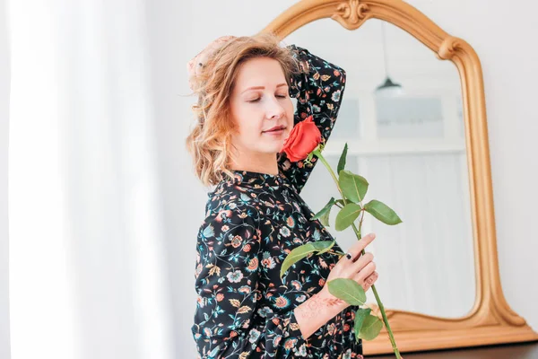 Linda romântica jovem loira no vestido com vermelho subiu perto do espelho — Fotografia de Stock