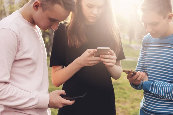 Grupa młodych przyjaciół nastolatków korzystających z telefonu na ulicy miasta — Zdjęcie stockowe