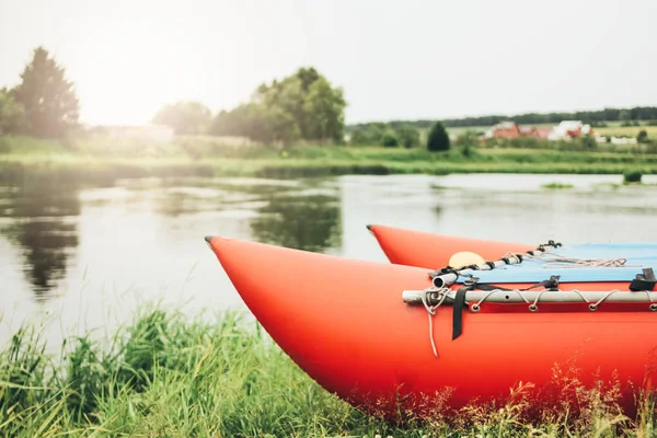 Inflatable catamaran for river rafting and fishing on grass shore — Stock Photo, Image