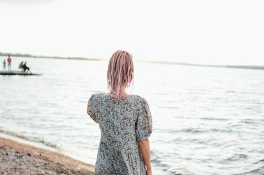 Sahilde elbise Afrika örgü ile güzel romantik genç kadın, arkadan görünüm, yaz tatil zamanı