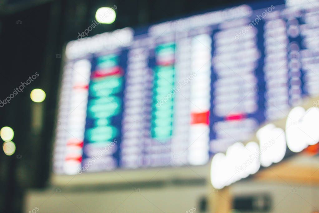 Blurred background of the electronic scoreboard with flights in international airport 