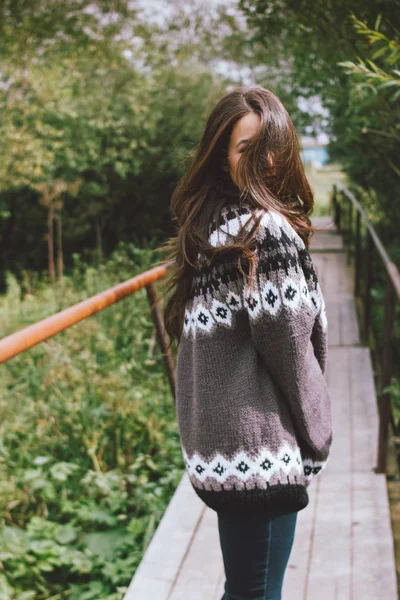 Beautiful carefree long hair asian girl in knitted nordic sweater in autumn nature park — Stock Photo, Image