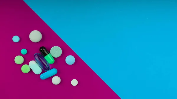 Colored pills on a bright background