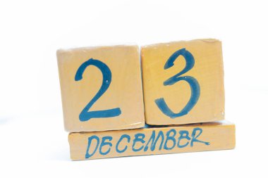 23 Aralık. Gün 23 ay, takvim ahşap arka plan üzerinde. El yapımı takvim.