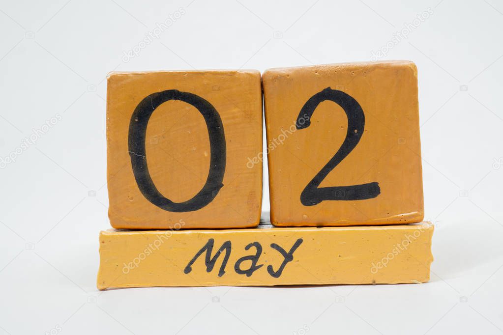may 2nd. Day 2 of month, handmade wood calendar isolated on white background. Spring month, day of the year concept.