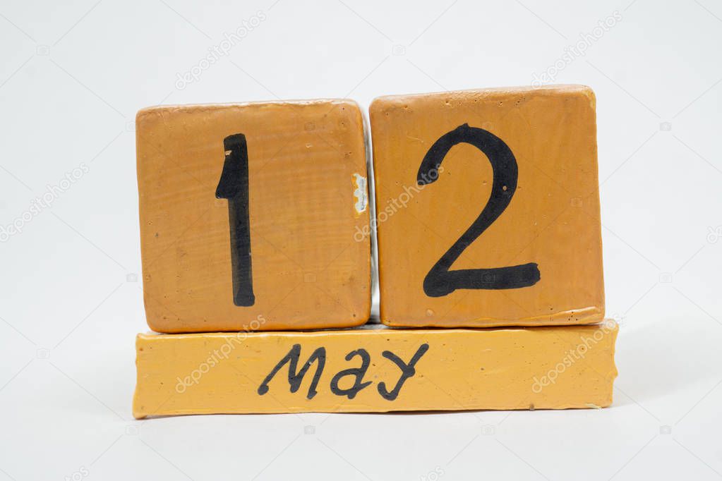 may 12th. Day 12 of month, handmade wood calendar isolated on white background. Spring month, day of the year concept.