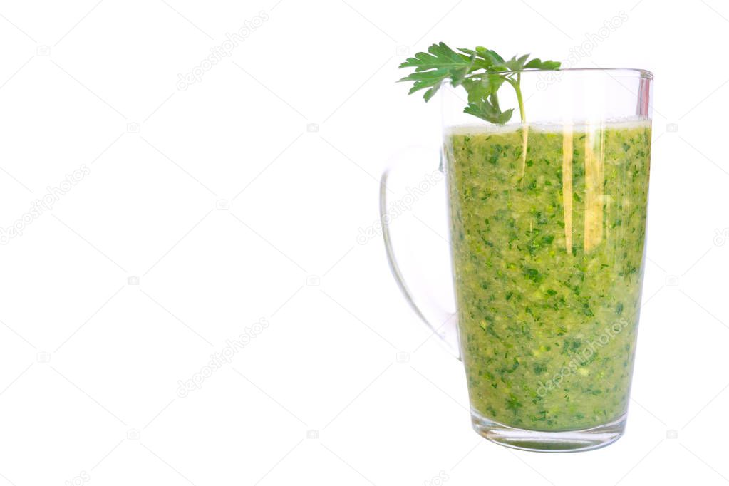 Green fruit and vegetable smoothie with a sprig of parsley in a transparent glass mug on a white background. healthy diet. food high in vitamins
