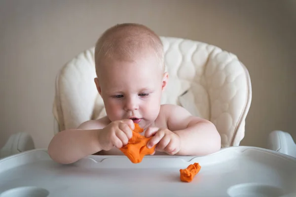 La créativité des enfants. le bébé essaie de sculpter à partir d'argile. Mignon petit garçon moule de plasticine sur la table — Photo