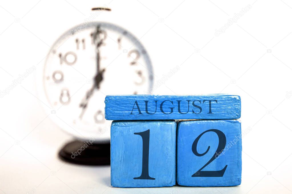 august 12th. Day 12 of month, handmade wood calendar  on modern blue color background. summer month, day of the year concept