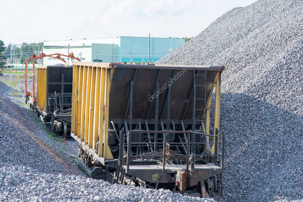 The railway carriage on loading with crushed stone. transportation of bulk materials. railway track maintenance
